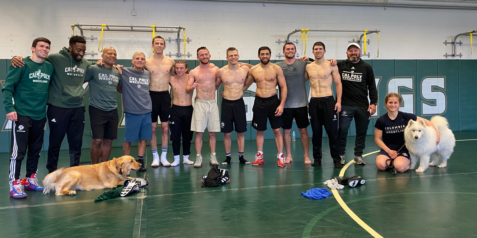 Wrestlers and coaches together in the Cal Poly wrestling room